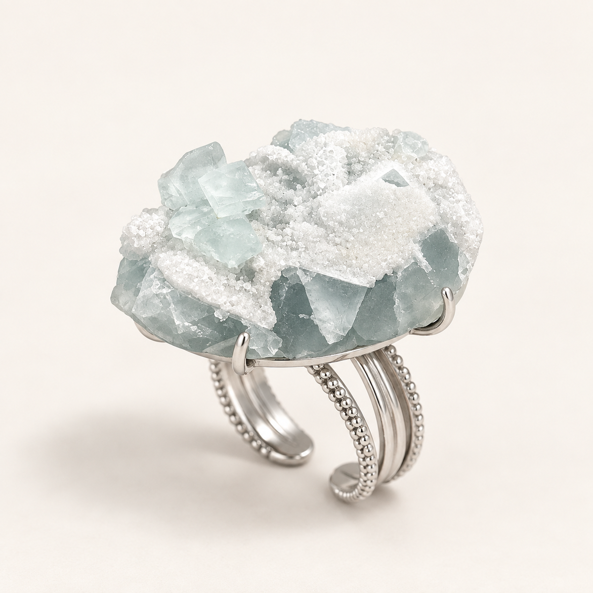 Glacier Bloom Ring three-quarter view showing the pale aqua cluster and multi-rail band