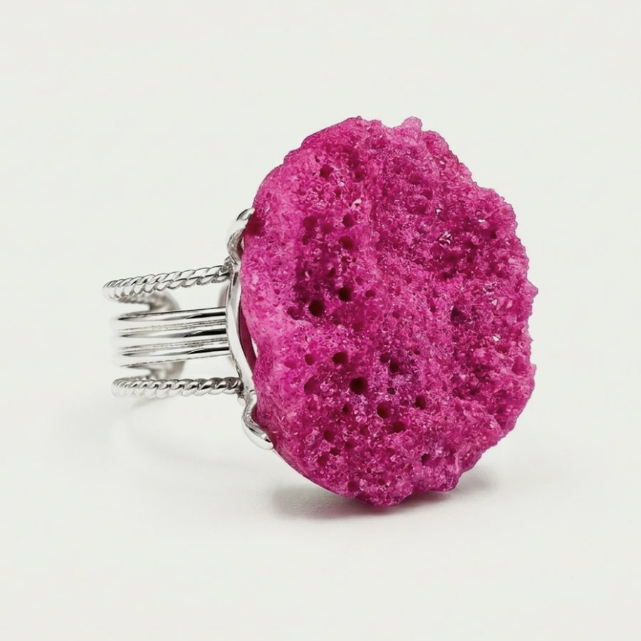 Front view of Wild Orchid, a sculptural ring with magenta tones.
