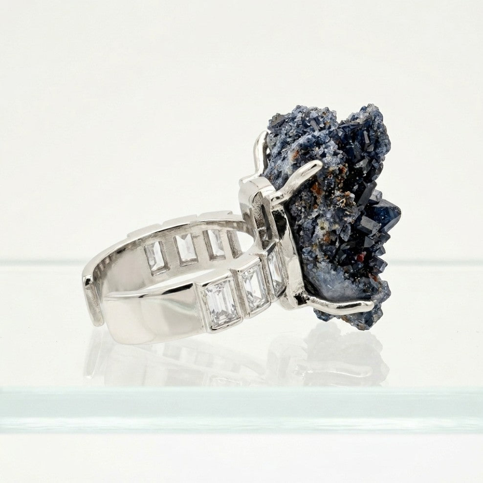 Side profile of Ocean Flame, showing its deep blue mineral form, warm copper-toned traces and silver-toned setting.