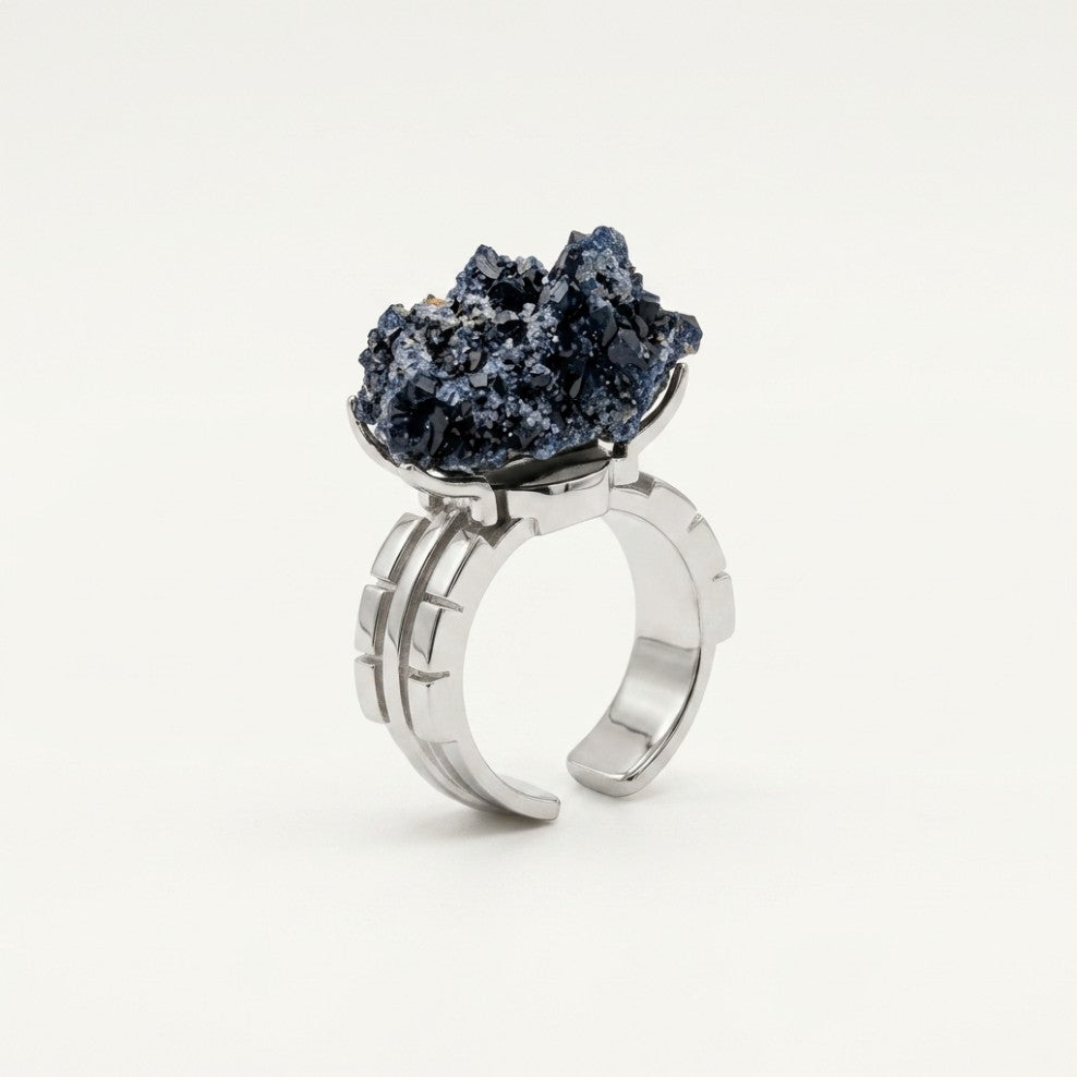 Ocean Flame ring in blue and warm copper tones, shown from the rear with its visible ring silhouette.