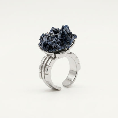 Ocean Flame ring in blue and warm copper tones, shown from the rear with its visible ring silhouette.