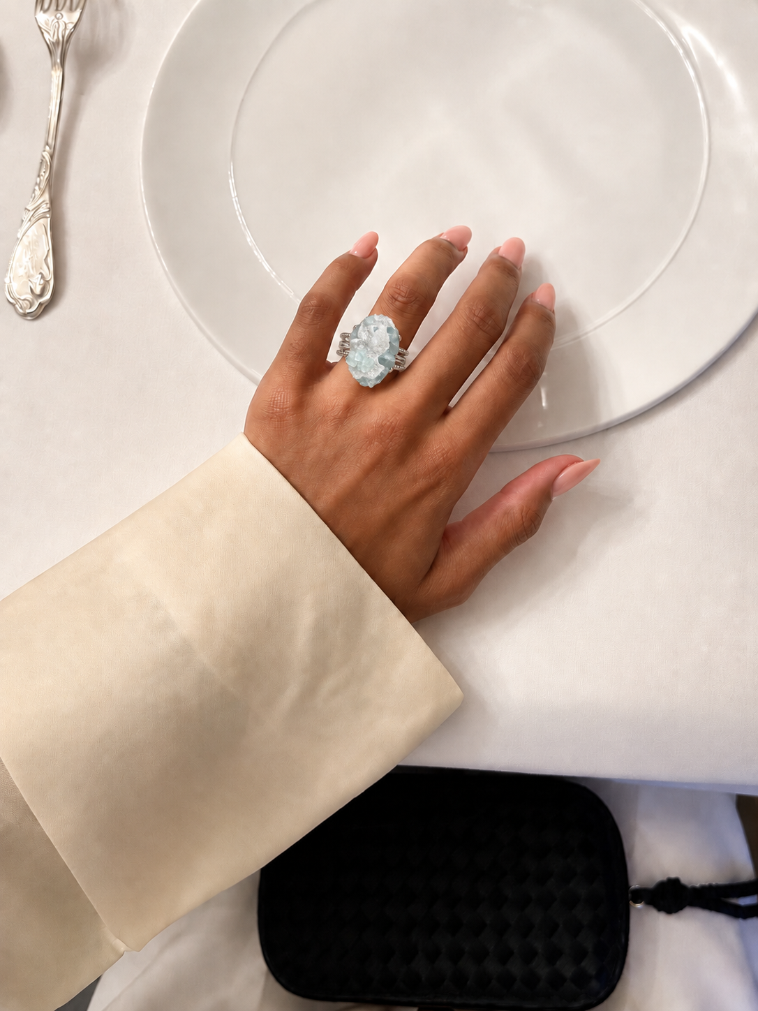 Glacier Bloom Ring styled with a cream sleeve at a bright table